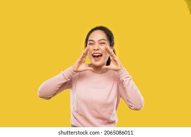 portrait of woman screaming holding two hands near mouth