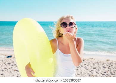 Portrait of a woman at the sea. Blonde having fun on the beach.