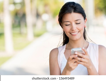 Portrait Of A Woman Sending Text Message From Her Phone