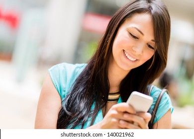 Portrait of a woman sending text message from her phone