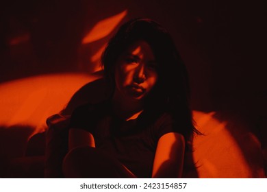 Portrait of a woman shot with red light and shadows on the face - Powered by Shutterstock