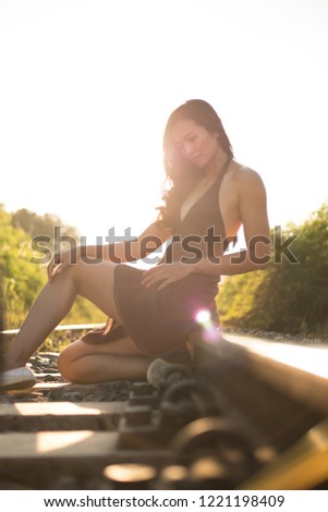 Similar – Beautiful young photographer woman wearing black clothes, sitting on the floor in countryside with her camera