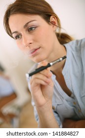 Portrait of woman smoking with electronic cigarette