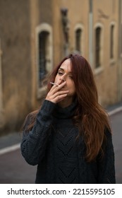 Portrait Of A Woman Smoking Outside