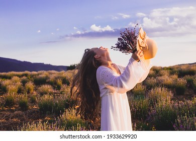 Portrait of woman is standing among the plantations of lavender - Powered by Shutterstock