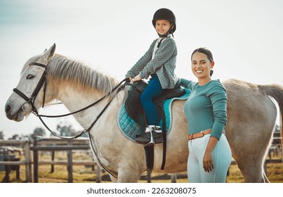 .Portrait of woman standing, child on horse and ranch lifestyle with smile and equestrian sports on field. Countryside, rural nature and farm animals, mother teaching girl to ride stallion in USA. - Powered by Shutterstock