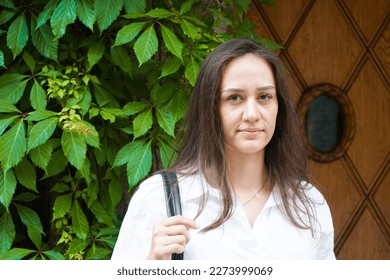 Portrait of a woman standing in front of a door - Powered by Shutterstock