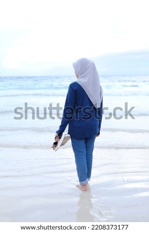 Portrait of woman standing on beach sand