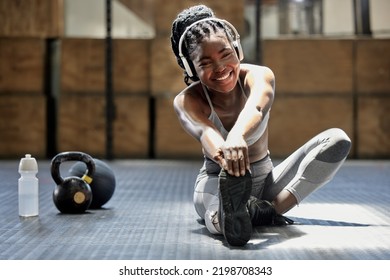 Portrait Of Woman Stretching With Music At Gym, Audio Podcast For Workout Motivation And Happy About Fitness Training On Floor At Health Club. African Athlete Or Sports Person Doing Exercise