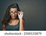 Portrait, woman and surprise with glasses in studio for space, eye care or wow lens of prescription solution. Shocked, girl and designer eyewear for consultation deal, gossip news and grey background