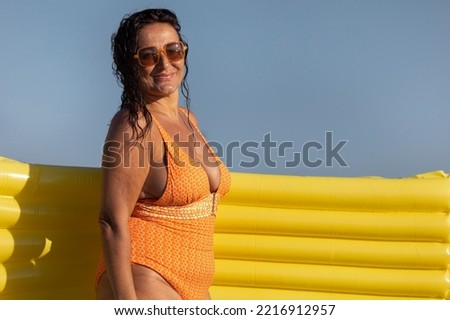 Similar – Brunette surfer woman with top and bikini holding surfboard