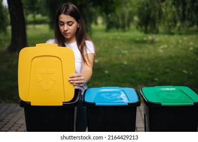 Portrait Woman Throwing Empty Plastic Water Bottle In Recycling Bin. Tree Recycling Bins Outdoors