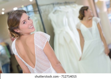 Portrait Of Woman Trying On Wedding Dress