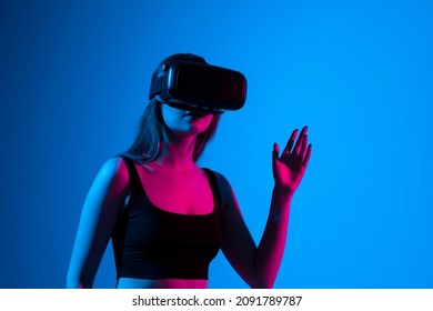 Portrait Of Woman Video Game Designer Wearing VR Headset And Interact With Virtual Environment Or Application.