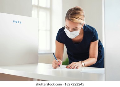 Portrait Of Woman Voter With Face Mask In Polling Place, Elections And Coronavirus Concept.