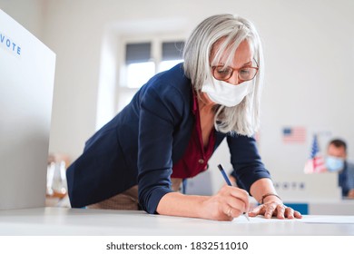 Portrait Of Woman Voter With Face Mask In Polling Place, Elections And Coronavirus Concept.