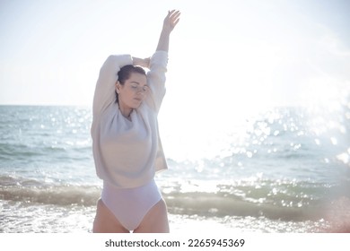 The portrait of woman walking in the beache in sprin weather - Shutterstock ID 2265945369