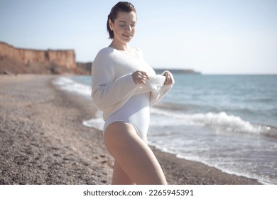 The portrait of woman walking in the beache in sprin weather - Shutterstock ID 2265945391