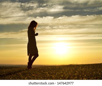 Portrait of a Woman walking thoughtfully at sunset