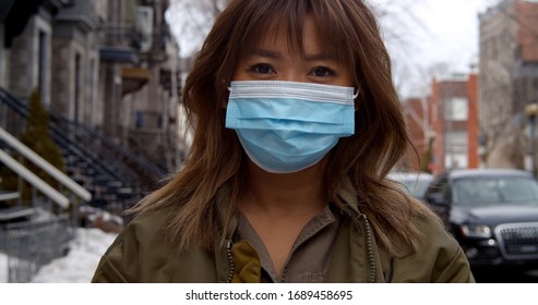 Portrait Of Woman Wearing Face Mask  During Coronavirus Pandemic Protecting Herself Against Pathogens
