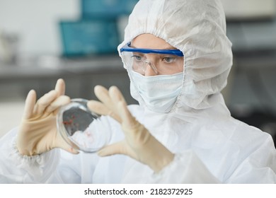 Portrait Of Woman Wearing Full Protective Gear While Analyzing Blood Samples In Medical Laboratory