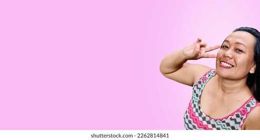 Portrait of Woman Wearing Pattern Dress and isolated on pinkbackground