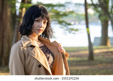 Portrait Of A Woman Wearing A Trench Coat.