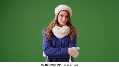 Portrait Of Woman Wearing Winter Clothing And Looking At Camera On Green Screen