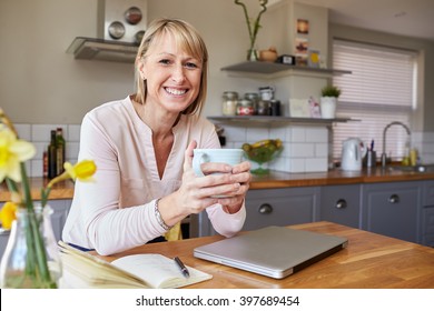 Portrait Of Woman Working From Home On Laptop In Apartment