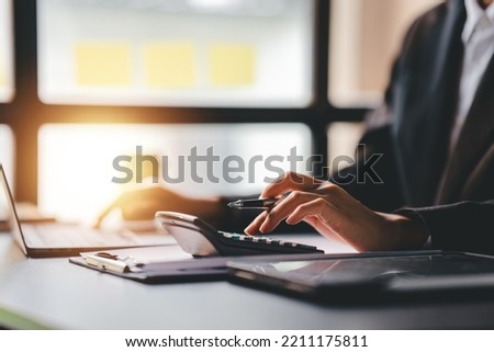 Portrait of a woman working on a tablet computer in a modern office. Make an account analysis report. real estate investment information financial and tax system concepts