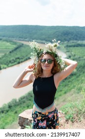 Portrait Of A Woman With A Wreath Of Daisies And Cumin On Her Head. Vacation Concept