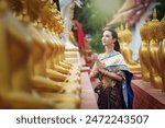 Portrait women in traditional clothing , Asia woman in Thai dress traditional women in traditional Dress on Buddhist on background.  Thai traditional in Ayutthaya Thailand.thai model portrait .