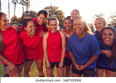 Portrait Of Womens Football Team Relaxing After Training For Soccer Match On Outdoor Pitch