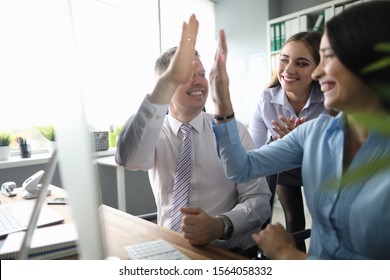 Portrait of wonderful businessman and businesslady happy about international deal. Perfect businesspeople giving fives from happiness. Business teamwork concept - Shutterstock ID 1564058332