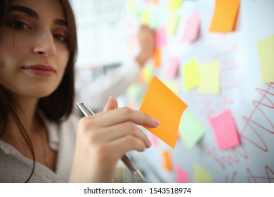 Portrait of wonderful businesswoman doing notes on marker board. Business meeting and company concept. Empty copy space on color sticker. Blurred background - Shutterstock ID 1543518974