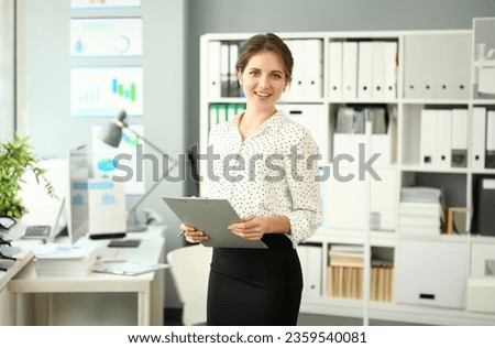 Portrait of wonderful smiling businesswoman in conference room. Woman looking at camera with happiness and posing in international company. Business meeting concept. Blurred background