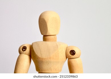 A portrait of a wooden art mannequin in a neutral standing position. The articulated joints and simple design make it ideal as an art tool for drawing or sketching human figures. - Powered by Shutterstock