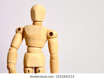 A portrait of a wooden art mannequin in a neutral standing position. The articulated joints and simple design make it ideal as an art tool for drawing or sketching human figures. - Powered by Shutterstock