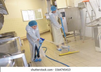 portrait of worker cleaning the kitchen area