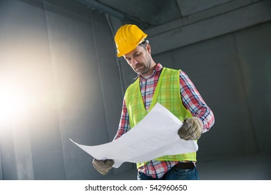 Portrait Of A Worker, Constructing And Checking Development Of A Small Business Hall. Reliable Civil Engineer Working On A Construction Site, Foreman At Work