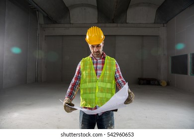 Portrait Of A Worker, Constructing And Checking Development Of A Small Business Hall. Reliable Civil Engineer Working On A Construction Site, Foreman At Work