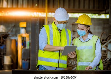 Portrait worker and engineer under inspection and checking production process on factory station by wearing safety mask to protect for pollution and virus in factory. - Shutterstock ID 1913865004