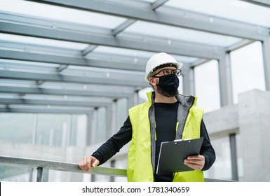 Portrait Of Worker With Face Mask At The Airport, Holding Clipboard.