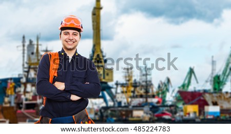 Portrait of a worker in front of an harbor