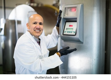 Portrait Of Worker Near Cisterns With Raw Milk

