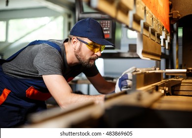 Portrait Of Worker Near Metalworking Machine, Steel Factory Background.