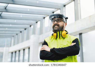 Portrait Of Worker With Protective Shield Standing At The Airport.