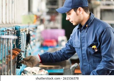 Portrait Of A Worker Searching For The Right Tool