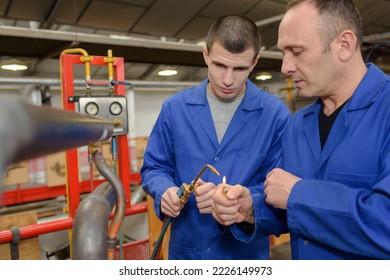 portrait of workers lighting gas torch - Powered by Shutterstock