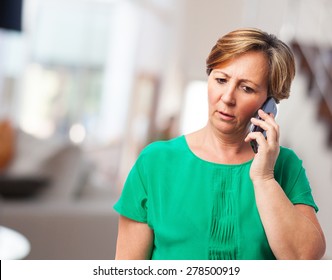 Portrait Of A Worried Mature Woman Talking On Telephone